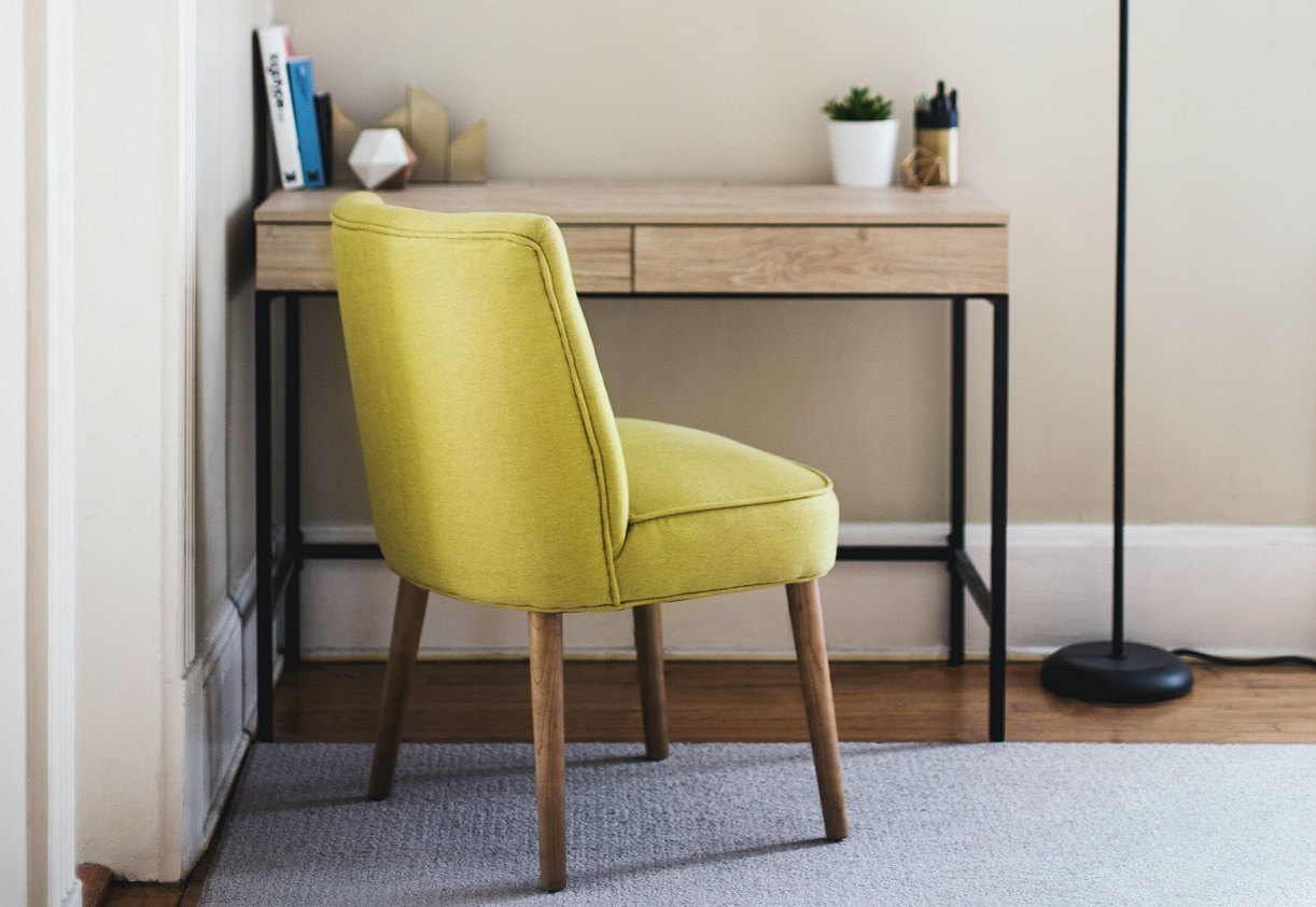 green chair in front of a wooden desk